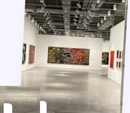 Art gallery interior with abstract paintings on white walls